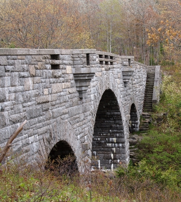 [Bridge along left side with stairs parallel to the bridge and leading from the top to the bottom of the nearest arch.]